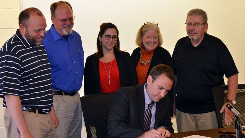 The Vandalia-Butler school board wit Superintendent Rob O’Leary signing his new contract with the district in May. Left to right, standing: Rodney Washburn, George Moreman, Missy Pruszynski, Vice President Mary Kilsheimer, and President Bob Cupp. CONTRIBUTED PHOTO