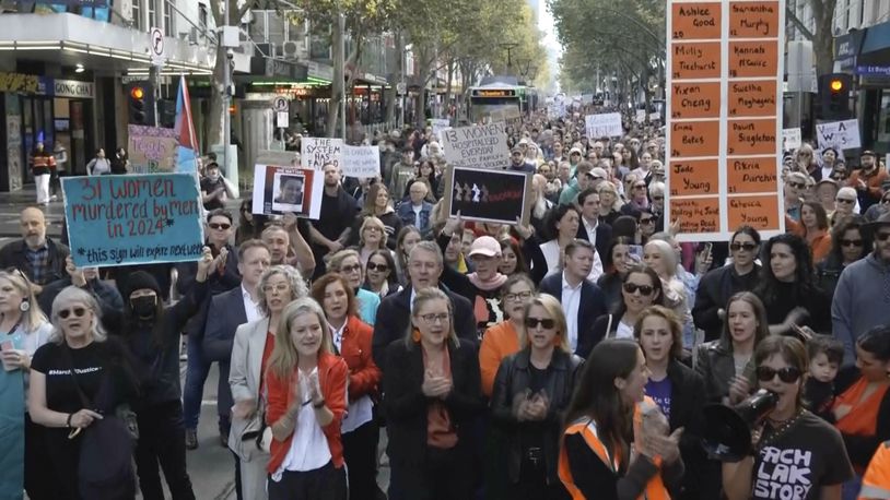 In this image made from video provided by AUBC, people march and shout slogans during a protest against gender-based violence, in Melbourne, Australia, Sunday, April 28, 2024. Thousands of people rallied across Australia on Sunday, demanding action to end gender-based violence in the country. (AUBC via AP)