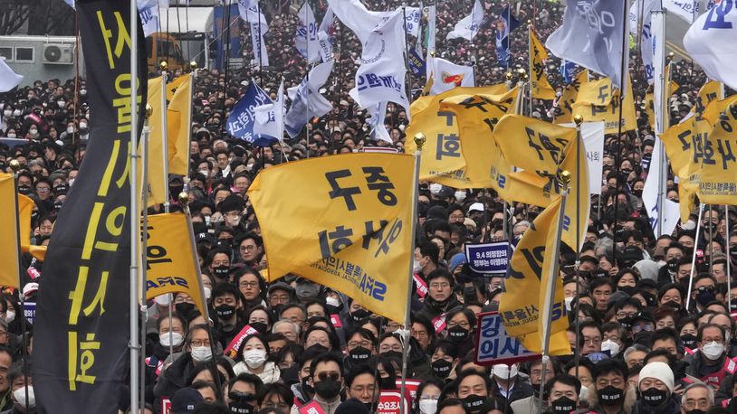 FILE - Doctors stage a rally against the government's medical policy in Seoul, South Korea, on March 3, 2024. South Korean police said Friday, April 26, they searched the office of the hard-line incoming leader of an association of doctors and confiscated his mobile phone as he faces accusations that he incited the protracted walkouts by thousands of medical interns and residents. (AP Photo/Ahn Young-joon, File)