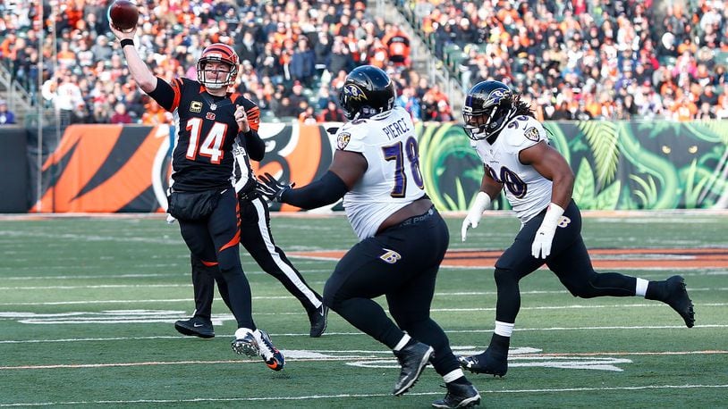 CINCINNATI, OH - JANUARY 1: Andy Dalton #14 of the Cincinnati Bengals throws a pass while being pressured by Michael Pierce #78 of the Baltimore Ravens and Za’Darius Smith #90 of the Baltimore Ravens during the second quarter at Paul Brown Stadium on January 1, 2017 in Cincinnati, Ohio. (Photo by Michael Hickey/Getty Images)