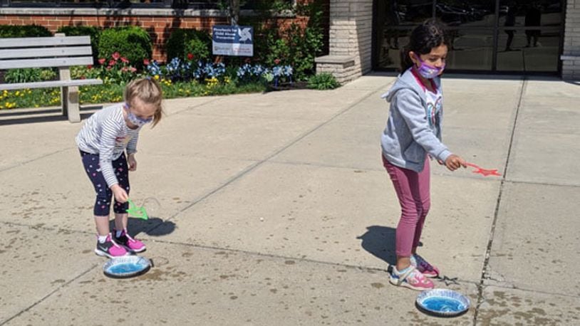 Students at Main Elementary School in Beavercreek take part in a “bubbles and water” experiment during the Wizards of Wright! program presentation in April. (Contributed photo)