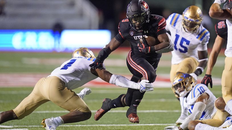 Utah running back Tavion Thomas (9) carries the ball for a touchdown as UCLA defensive back Stephan Blaylock (4) tries to defend in the second half during an NCAA college football game Saturday, Oct. 30, 2021, in Salt Lake City. (AP Photo/Rick Bowmer)