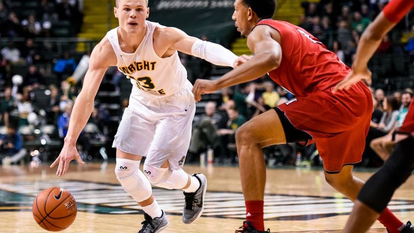 Wright State University’s Grant Benzinger dribbles to the hoop defended by Miami University’s Rod Mills, Jr. during their 89-87 win over Miami Tuesday, Nov. 15, 2016, at Wright State University’s Nutter Center in Fairborn. NICK GRAHAM/STAFF