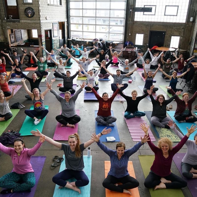 Warped Yoga is back at the Warped Wing Brewing Company. Shown is a class pre-COVID, as capacity is currently being capped at 20 and masks are being worn to and from participants' socially-distanced mats. CONTRIBUTED