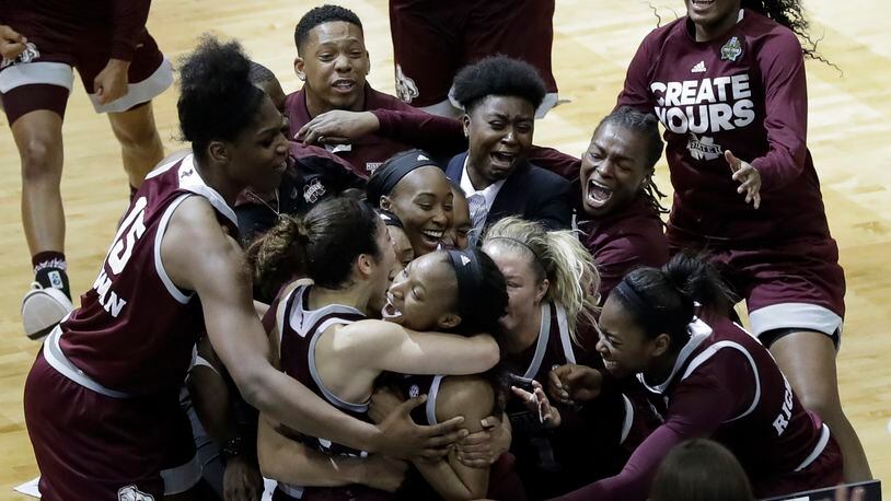 Mississippi State guard Morgan William, center, celebrates with teammates after she hit the winning shot at the buzzer in overtime to defeat Connecticut in an NCAA college basketball game in the semifinals of the women’s Final Four, Friday, March 31, 2017, in Dallas. Mississippi State won 66-64. (AP Photo/Eric Gay)
