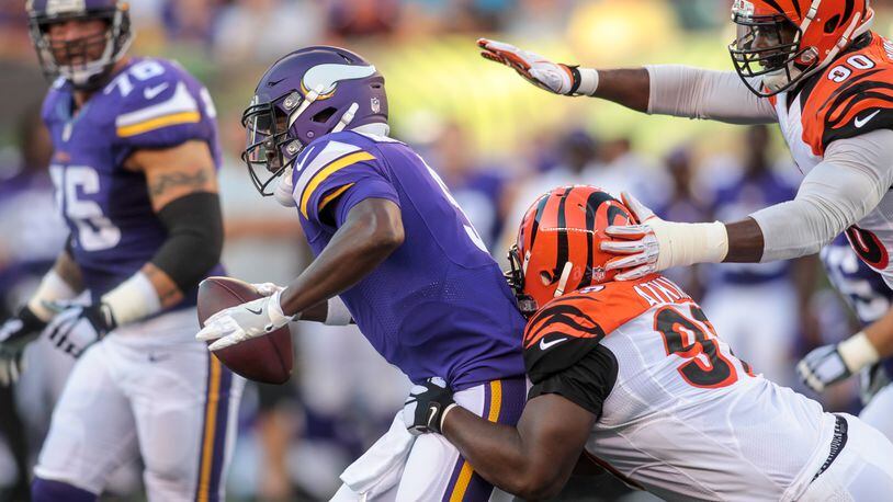Minnesota Vikings quarterback Teddy Bridgewater gets sacked by Geno Atkins and Michael Johnson, right, with the Cincinnati Bengals during the first quarter of their first pre-season game Friday, Aug. 12 at Paul Brown Stadium in Cincinnati. NICK GRAHAM/STAFF