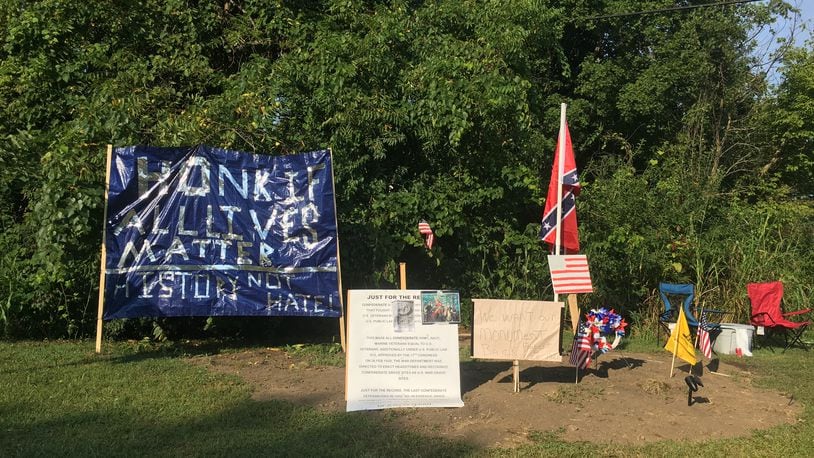 Banners as well as Confederate and American flags have been placed at the former site of a Confederate monument at the corner of Dixie Highway and Hamilton Middletown Road in Franklin. RICK McCRABB/STAFF