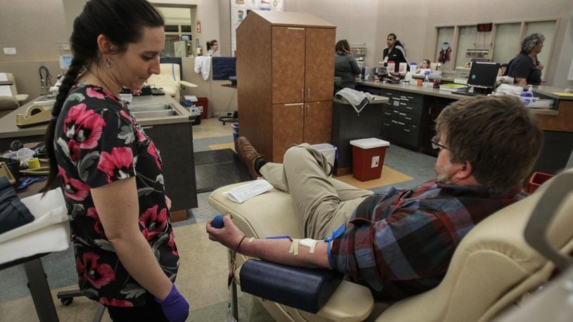 A man donates blood at the downtown Community Blood Center in Dayton on Thursday, March 19, 2020. JIM NOELKER/STAFF
