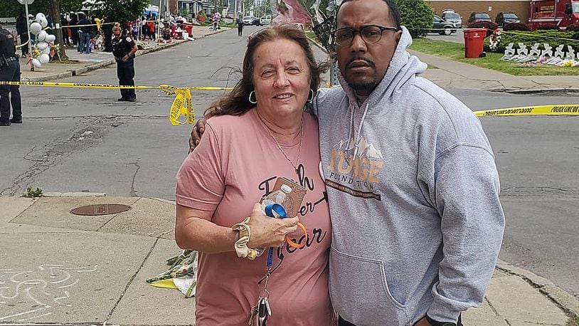 Dion Green, who lost his father in the Oregon District shooting, stands Wednesday with a woman he met outside Tops Supermarket, the scene of a recent mass shooting. Green said the woman was in need of support, so he hugged her and talked to her after he drove to Buffalo to help people impacted by the shooting. Contributed Photo