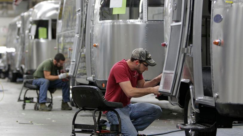 Jackson Center-based Airstream, a manufacturer of recreational vehicles or RVs, and Tommy Bahama, an “island-inspired lifestyle brand,” are partnering to create new RVs. In this 2014 photo, Jordan Peterson, of Bellefontaine, works on an Airstream travel trailer at the Airstream factory in Jackson Center, Ohio. (AP Photo/Jay LaPrete, File)