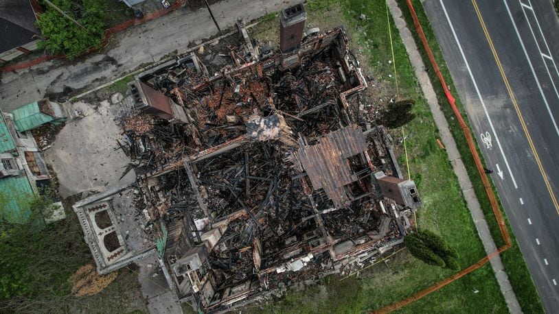 The Louis Traxler mansion, which was listed on the National Register of Historic Places, is shown here from above after an early morning fire April 23, just days before it was scheduled to be auctioned. JIM NOELKER/STAFF