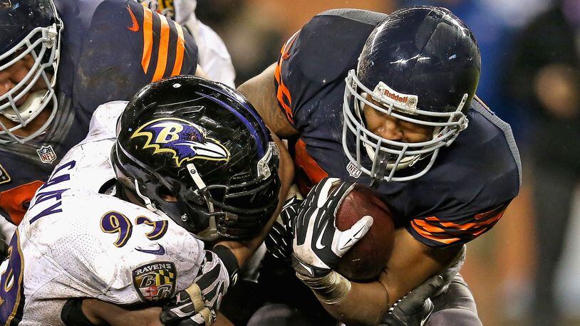 Matt Forte, formally of the Chicago Bears, is hit by Chris Canty #99 of the Baltimore Ravens at Soldier Field on November 17, 2013 in Chicago, Illinois. The Bears and Ravens face off Thursday, August 2, 2018 in the first NFL preseason game in Canton, Ohio.