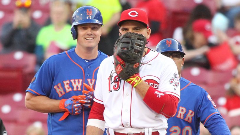The Mets’ Jay Bruce, left, talks to former Reds teammate Joey Votto after a walk on Monday, May 7, 2018, at Great American Ball Park in Cincinnati. David Jablonski/Staff