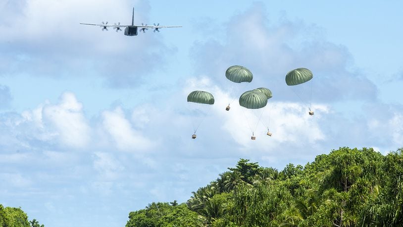 A U.S. Air Force C-130J Super Hercules out of Yokota Air Base, Japan, delivers five low-cost, low-altitude humanitarian aid bundles filled with critical supplies as part of Operation Christmas Drop to the island of Woleai, Federated States of Micronesia, Dec. 10. In its 68th year, Operation Christmas Drop is the world’s longest-running airdrop training mission, providing critical supplies to 55 remote Micronesian islands like Woleai, impacting approximately 20,000 people across 1.8 million square nautical miles of operating area. (U.S. Air Force photos/Senior Airman Matthew Gilmore)