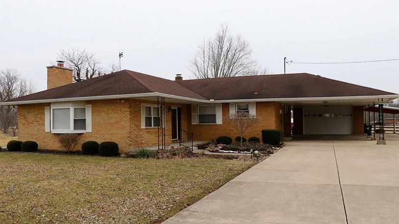 This 3-bedroom brick ranch sits on double parcel, which includes 4 acres. The house has 2 carports, a 2-car garage, a rear deck, semi-finished basement, concrete driveway with extra parking pad and a metal pole barn. CONTRIBUTED PHOTOS BY KATHY TYLER