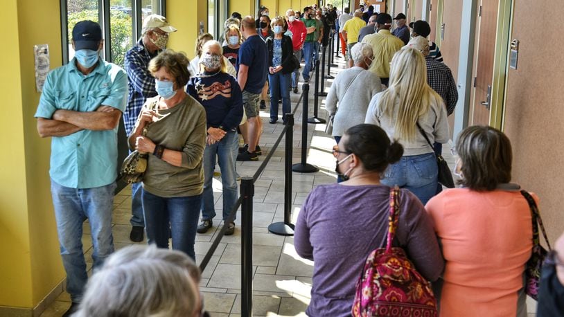 Voters line up at the Butler County Board of Elections on the first day of early voting Tuesday, October 6, 2020 in Hamilton. NICK GRAHAM / STAFF