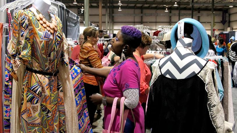 Rhonda Faye of Dayton browses through clothing at the Dayton Women's Fair which kicked off Saturday at the Airport Expo Center in Vandalia. The event, which features local and regions merchants, food, fashion and fun, continues Sunday from 10 a.m. to 5 p.m. LISA POWELL / STAFF PHOTO