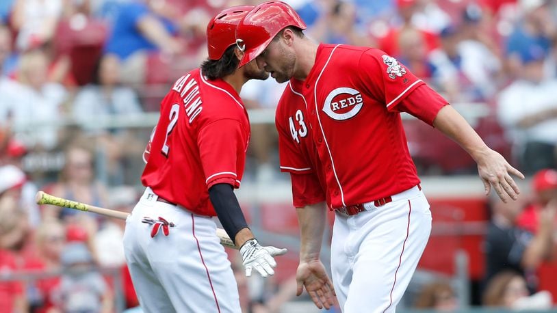 CINCINNATI, OH - JUNE 24:  Alex Blandino #2 of the Cincinnati Reds congratulates Scott Schebler #43 after scoring the go ahead run during the seventh inning of the game against the Chicago Cubs at Great American Ball Park on June 24, 2018 in Cincinnati, Ohio. Cincinnati defeated Chicago 8-6. (Photo by Kirk Irwin/Getty Images)