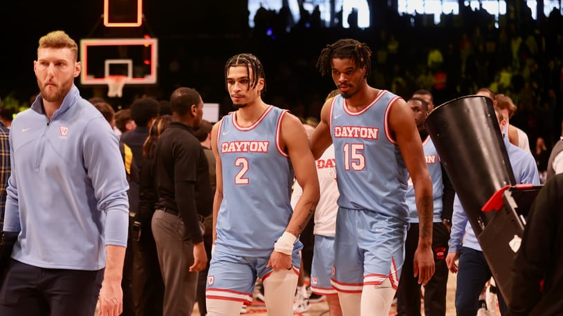 Dayton's Toumani Camara and DaRon Holmes II leave the court after a loss against Virginia Commonwealth in the Atlantic 10 Conference championship game on Saturday, March 12, 2023, at the Barclays Center in Brooklyn, N.Y. David Jablonski/Staff