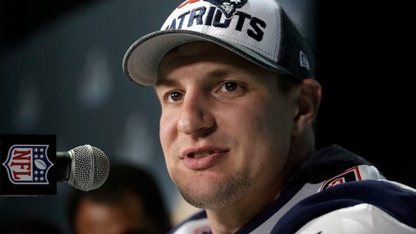 FILE - In this Feb. 4, 2018, file photo, New England Patriots tight end Rob Gronkowski answers questions during a news conference ahead of the Super Bowl, in Minneapolis.  Police have arrested a second suspect in connection with a burglary at Gronkowski's Massachusetts home while he was at the Super Bowl. Authorities say 28-year-old Eric Tyrell, who was wanted on two counts of receiving stolen property, turned himself in Tuesday, March 27, 2018. (AP Photo/Mark Humphrey, File)
