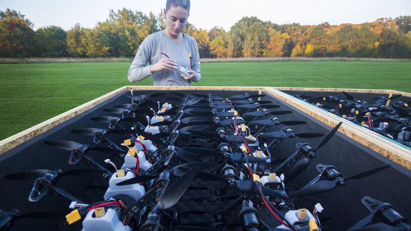 Firefly Drone Shows’ Brea Dorosz, 25, of Lake Orion helps prepare 60 drones in a field near Holly, Mich. on Tuesday, Oct. 9, 2018 to test an upcoming show. Firefly Drones, a company out of Lake Orion, uses multiple drones to swarm, creating incredible evening light shows. The company started this year and has already been used across the country, including a show at the Rouge Factory celebration. (Mandi Wright/Detroit Free Press/TNS)