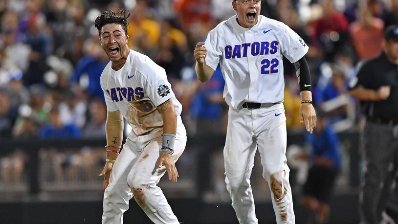 OMAHA, NE - JUNE 27: Players J.J. Schwarz #22 and Jonathan India #6 of the Florida Gators celebrate after beating the LSU Tigers 6-1 to win the National Championship at the College World Series on June 27, 2017 at TD Ameritrade Park in Omaha, Nebraska. (Photo by Peter Aiken/Getty Images)