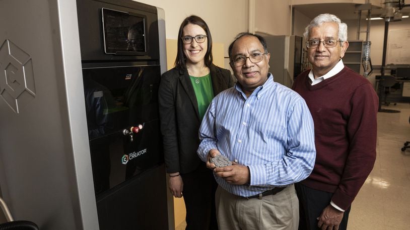 From left: Wright State University Department of Mechanical and Materials Engineering faculty members Joy Gockel, Ahsan Mian and Raghu Srinivasan stand beside the ORLAS Creator 3D printer. Photo by Erin Pence