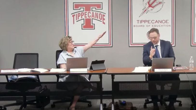 Tipp City school board member Anne Zakkour performs a Nazi salute gesture toward President Simon Patry during a heated exchange Tuesday during a meeting.