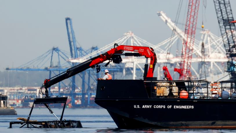 The U.S. Army Corps of Engineers debris removal vessel The Reynolds works near the collapsed Francis Scott Key Bridge, Monday, April 15, 2024, in Baltimore. The FBI confirmed that agents were aboard the Dali conducting court-authorized law enforcement activity. (AP Photo/Julia Nikhinson)