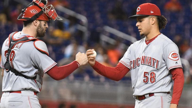 MIAMI, FL - SEPTEMBER 21: Luis Castillo #58 of the Cincinnati Reds is congratulated by Curt Casali #38 after pitching nine scoreless innings against the Miami Marlins at Marlins Park on September 21, 2018 in Miami, Florida.  (Photo by Eric Espada/Getty Images)