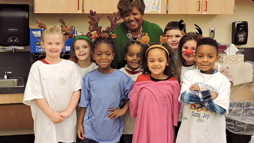 State board of education member Charlotte McGuire poses with students during a visit to Northmont City Schools. FILE PHOTO