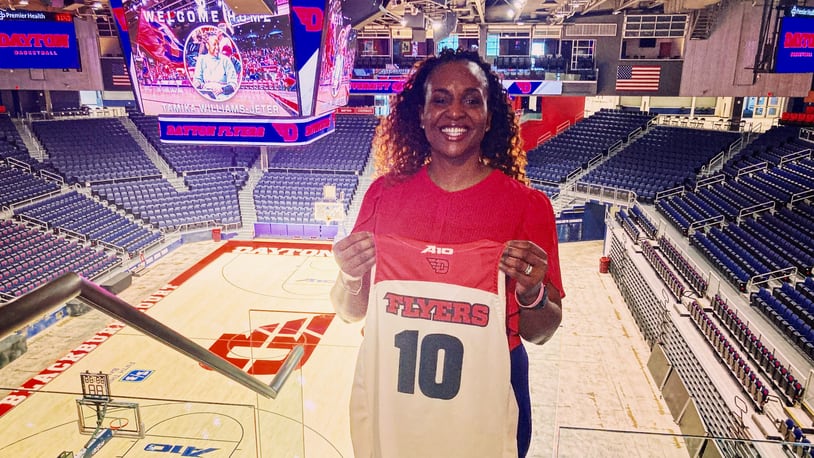 Tamika Williams-Jeter poses for a photo after being introduced as the new head women's basketball coach at Dayton on Monday, March 28, 2022, at UD Arena. David Jablonski/Staff