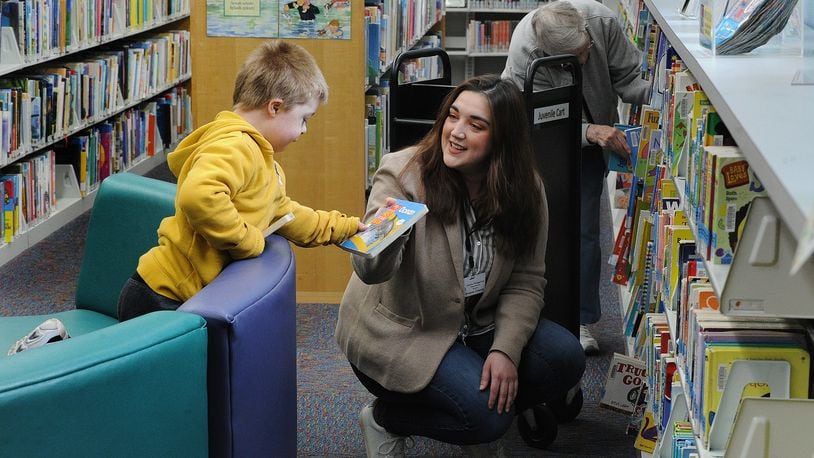 Wesley Smallwood, 6, gets help picking out a book from Head Librarian, Jessica Winegarner, middle, and Library Aide, Joan Taylor at the Fairborn Community Library Thursday, April 28, 2022. MARSHALL GORBY\STAFF