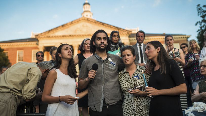 From left: Danielle Ohl, Phil Davis, Rachael Pacella, and Selene San Felice, reporters at the Capital Gazette, address the crowd during a vigil for the victims of the newsroom shooting in Annapolis, Md., June 29, 2018. The crowd held candles and passed around white flowers in the fading light and stifling heat, trying to make sense of a new front in mass shootings: an attack on a local newspaper. (Ryan Christopher Jones/The New York Times)