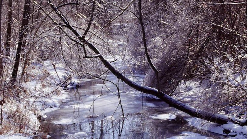The photographs of nature photographer and author Raymond J. Mueller are on display at Aullwood Audubon Center. This one is titled “Snowy Stream.” SUBMITTED