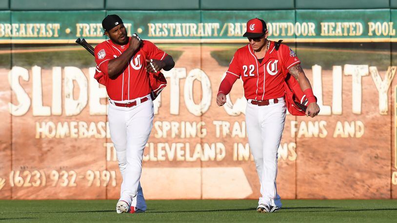 The Reds are full of new faces this year, like outfielder Yasiel Puig (left) and utility player Derek Dietrich. (Photo by Norm Hall/Getty Images)