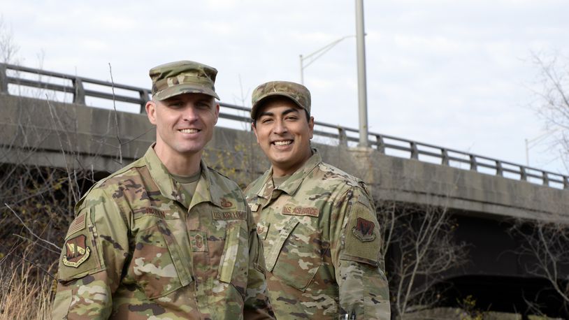 U.S. Air Force Senior Master Sgt. David Briden, left, Air Force Installation Contracting Center expeditionary operations manager, and Tech. Sgt. Anthony Staton, National Air and Space Intelligence Center, stand near the South Maple Avenue bridge in Fairborn, Ohio, on Nov. 20, 2020. Two days earlier, the Airmen assigned to Wright-Patterson Air Force Base stopped to aid a teen who was hanging over the side of the bridge and appeared to be in distress. They stayed with the teen until police and medics arrived. (U.S. Air Force photo by Ty Greenlees)