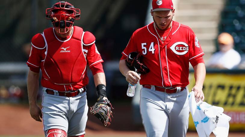 Cincinnati Reds pitcher Rookie Davis (54) walks in from the bullpen after warming up with catcher Devin Mesoraco, left, prior to the team’s spring training baseball game against the Kansas City Royals Monday, March 20, 2017, in Surprise, Ariz. (AP Photo/Ross D. Franklin)