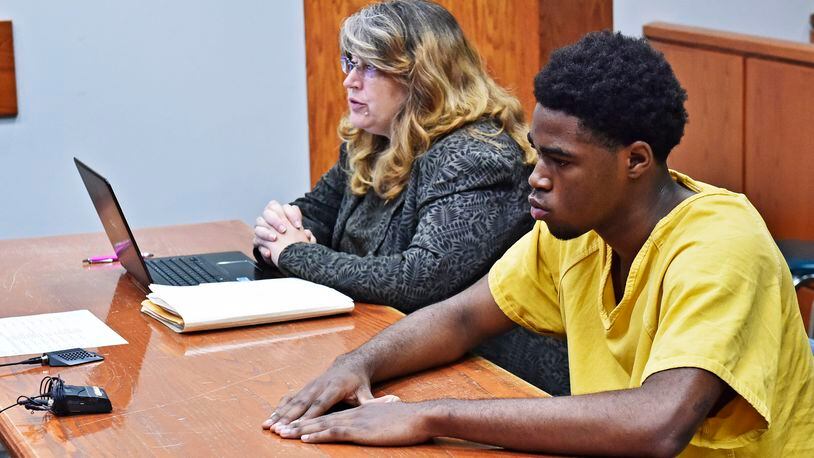 A 16-year-old Middletown teen will be tried as an adult following a hearing Friday, Aug. 10 in Butler County Juvenile Court. Gonnii White, sitting with attorney Dawn Garrett, is charged with murder and participating in a criminal gang in the shooting death of Joseph Davis, 17, near the corner of Woodlawn Avenue and Garfield Street during the late night hours of May 29. NICK GRAHAM/STAFF