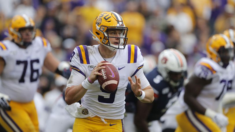 FILE - In this Oct. 26, 2019, file photo, LSU quarterback Joe Burrow (9) scrambles during the first half of the team's NCAA college football game against Auburn in Baton Rouge, La. Burrow was selected first in the 2020 NFL Draft by the Cincinnati Bengals and was among three 2017 Ohio State Buckeyes teammates picked in the top five.