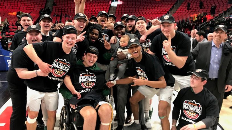 Wright State, including assistant coach Sharif Chambliss and son Julian (center), celebrate the Raiders’ win over Cleveland State in the Horizon League Championship game in 2018. CONTRIBUTED