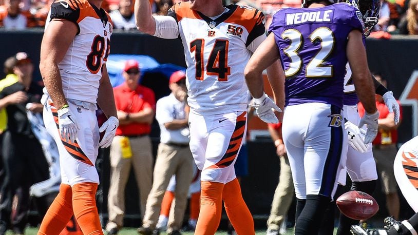 Cincinnati Bengals’ quarterback Andy Dalton signals for a first down after he gets his helmet ripped off during the play during their game against the Baltimore Ravens Sunday, Sept. 10 at Paul Brown Stadium in Cincinnati. NICK GRAHAM/STAFF
