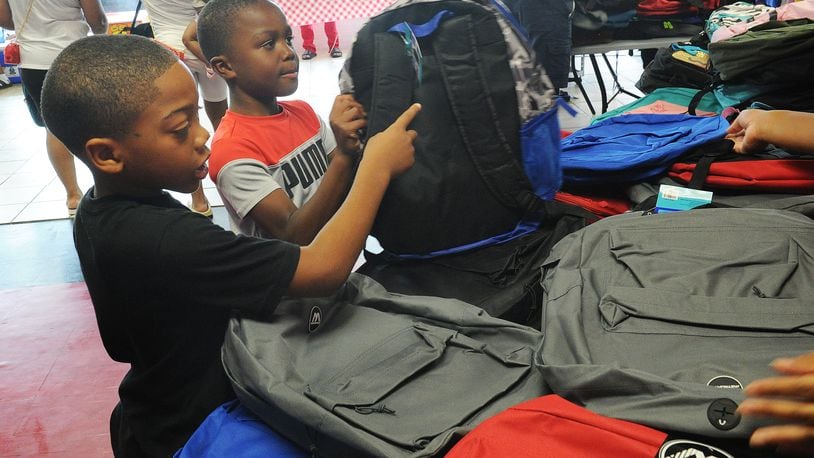 Exclusively Curved & Ladybug Delivery gave away over 350 backpacks full of school supplies Friday, Aug. 6, 2021. The business is located at 4823 Salem Ave. in Trotwood. MARSHALL GORBY\STAFF.