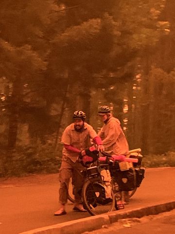 *EMBARGO: No electronic distribution, Web posting or street sales before THURSDAY 3:01 a.m. ET SEPT. 17, 2020. No exceptions for any reasons. EMBARGO set by source.**An image provided by Cindy Neblett, two evacuees arrived by bike amidst the fire in Detroit, Ore. After raging wildfires left them trapped on the shores of a reservoir near Detroit, Ore., dozens of people and nine firefighters mounted a last stand, hoping for a miracle. (Cindy Neblett via The New York Times)-- NO SALES; FOR EDITORIAL USE ONLY WITH NYT STORY ORE-WILDFIRES-ESCAPE BY JACK HEALY AND MIKE BAKER FOR SEPT. 16, 2020. ALL OTHER USE PROHIBITED. --