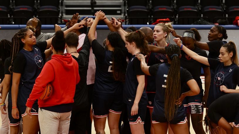 The Dayton women's basketball team huddles at practice on Tuesday, Oct. 4, 2022, at UD Arena. David Jablonski/Staff