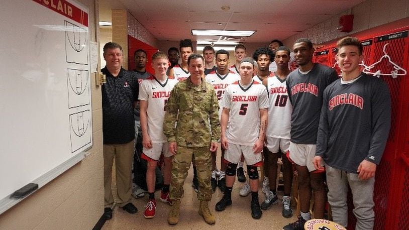 Colonel Paul Burger, Commander off 88th Mission Support Group at Wright Patterson Air Force Base, poses with the Sinclair men’s basketball team in locker room just before Monday’s game as part of Military Appreciation Night. Eric Deeters/Sinclair Community College