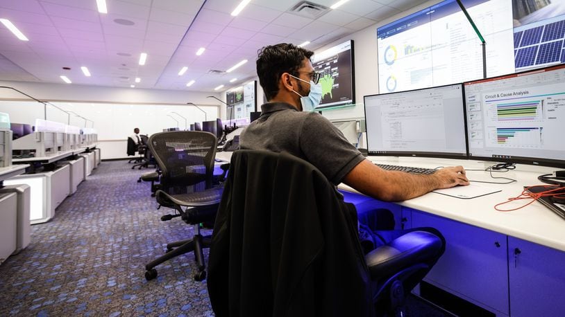 AES data scientist Kashyap Mehta works in his new office at the newly remodeled AES smart operations center on Woodman Drive in this file photo. AES spent $20 million to renovate the old Dayton Power & Light building. JIM NOELKER/STAFF