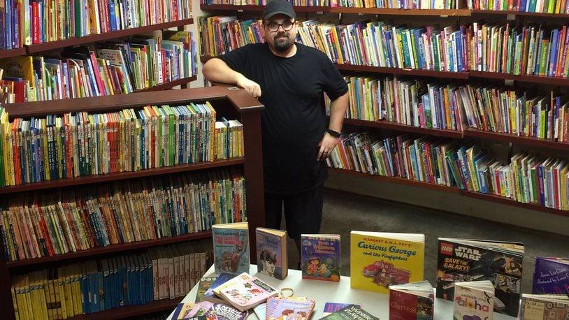 Greg Murphy in the children’s book room of One Dollar Book Swap, which opened in July. CONTRIBUTED