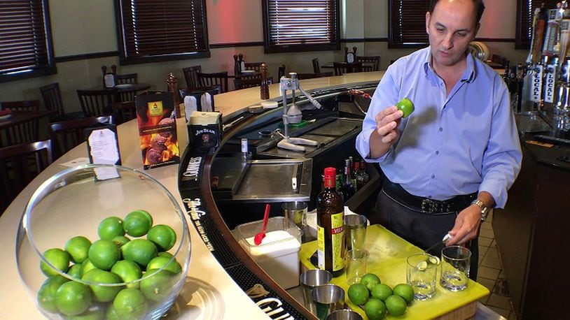 Edson Ludwig of Porto do Sul in Overland Park, demonstrates how to make the perfect caipirinha. Some bartenders are taking liberties with Brazil's national cocktail. (Tammy Ljungblad/Kansas City Star/TNS)