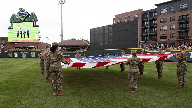 Airmen from Wright-Patterson Air Force Base display a large American flag during Day Air Ballpark’s American Celebration night Aug. 13. The annual Dayton Dragons tribute included military static displays, posting of the colors by WPAFB’s Honor Guard, and the swearing-in of new Air Force and Marine recruits. U.S. AIR FORCE PHOTO/JAIMA FOGG